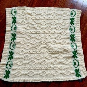 New Merino Wool baby blanket by Aran crafts. Never used. Measures 28 in.X 31 in.